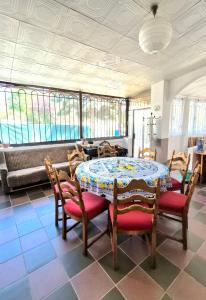 a dining room with a table and chairs and a couch at Таки Дача на Фонтане in Odesa