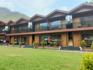 a building with a lawn in front of it at Aqua Forest River Resort in Bijni
