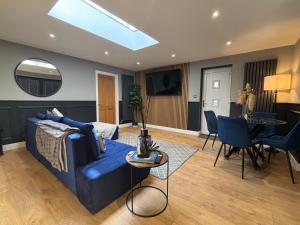 a living room with a blue couch and a table at Secret Escape in Sheffield