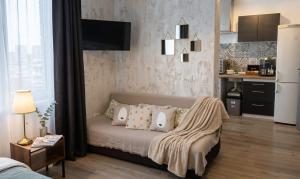 a bedroom with a bed with pillows and a kitchen at Casa Rahova - centru civic in Brăila +15 photos