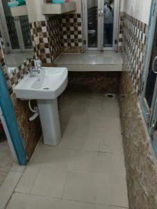 a bathroom with a sink and a toilet and a shower at Hotel Vasu in Gopālganj
