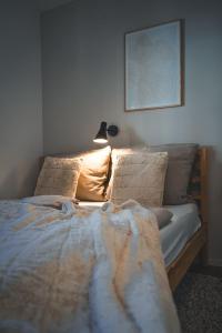 a bedroom with a bed and a lamp on the wall at Oskar Apartments in Neustift im Stubaital