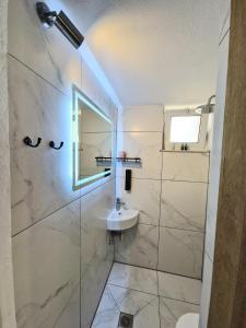 a bathroom with a sink and a mirror at Xenia Studios in Piskokéfalon +55 photos