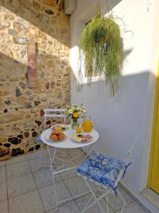 a white table with fruit and drinks on it at Xenia Studios in Piskokéfalon