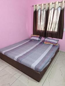 a large bed in a room with a window at Shiva Homestay Dwarka in Dwarka +12 photos