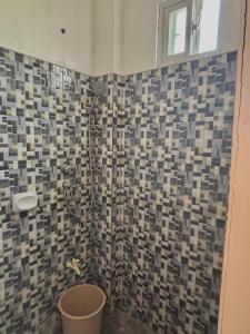 a bathroom with a shower with a trash can at Maru Vibe Studio unit in San Juan