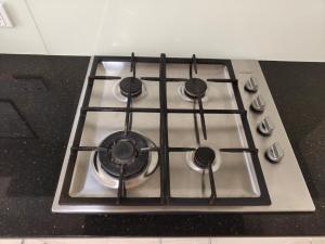 a stove top oven with four burners on it at Bright Double Room N Winston Hills in Toongabbie
