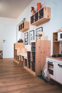 a kitchen with wooden cabinets and a table at Oskar Apartments in Neustift im Stubaital