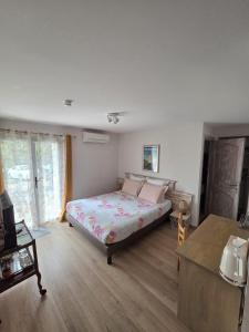 a bedroom with a bed in the middle of a room at Villa Manoe in Draguignan