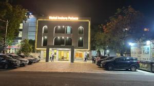 a large sign in front of a parking lot with cars at KDM Hotel Indore Palace- Newly Renovated 4 Star Premium Hotel in Shirdi