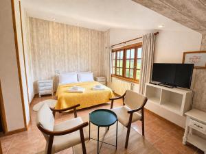 a bedroom with a bed and a table and chairs at Posada Adela in Santillana del Mar