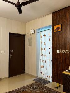 a room with a door with a curtain and a ceiling at Kavya royal in Mathura