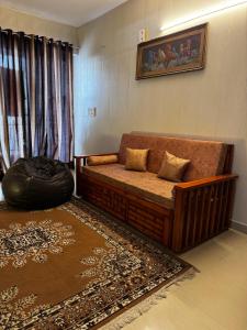 a living room with a couch and a window at Kavya royal in Mathura