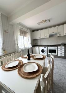 a kitchen with a table with two plates on it at Casa Ramona en Foz in Foz