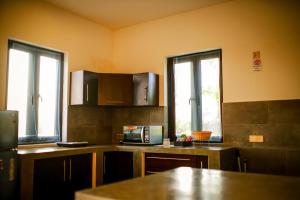 a kitchen with a counter top with a microwave at Nayan's Paradise in Kottanitivu