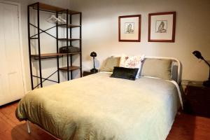 a bedroom with a bed and a book shelf at Homesaway Cottage in Kyneton
