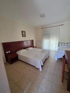 a bedroom with two beds with white sheets at Studio Filippos in Possidi +42 photos