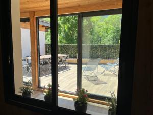 a view of a deck with a table and chairs at le saint genest in Vallouise
