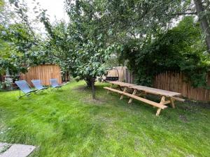 two chairs and a wooden picnic table in a yard at le saint genest in Vallouise +4 photos