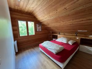 a bedroom with a bed in a wooden cabin at le saint genest in Vallouise