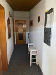 a hallway with a door and a table on a wall at Ferienwohnung Gisela in Lohsa +4 photos