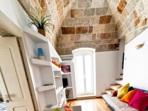 a living room with a stone wall at Brezza Marina in Polignano a Mare