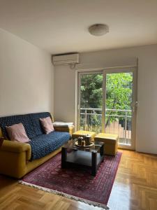 a living room with a couch and a coffee table at Mercury Apartments Budva in Budva