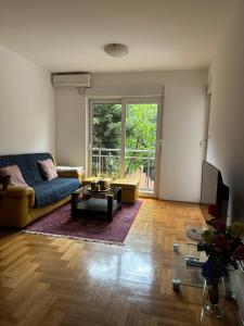 a living room with a couch and a table at Mercury Apartments Budva in Budva