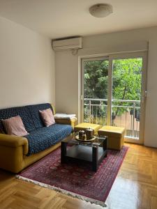 a living room with a couch and a coffee table at Mercury Apartments Budva in Budva