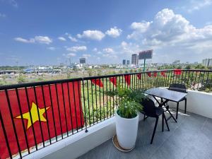 a balcony with a table and a star on the railing at Soha Hotel Cần Thơ in Cái Răng