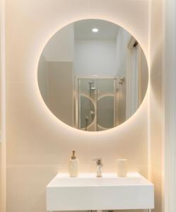 a bathroom with a white sink and a mirror at N'Ador Rooms in Naples