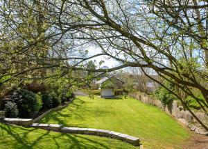 a large yard with a lawn with a house at Kilminorth Cottages in Trelaske