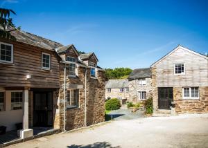 an old stone house with a garage and a barn at Kilminorth Cottages in Trelaske +184 photos