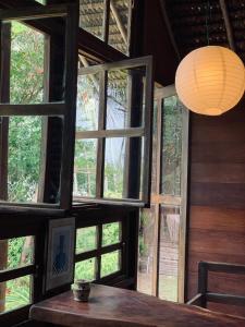 a room with a table and a large window at Casa Tassimirim in Ilha de Boipeba