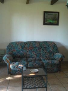 a living room with a couch and a table at Maison campagne in Charron