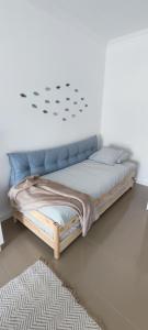 a bedroom with a bed with a blue headboard at Azurara Beach Nest in Azurara