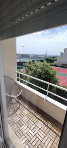 a balcony with a bench and a tennis court at Azurara Beach Nest in Azurara
