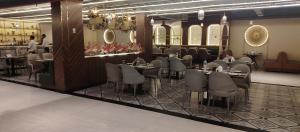 a restaurant with tables and chairs in a room at Hotel Renuka Inn A Unite shyam ganga builders in Deoria