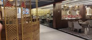 a restaurant with a dining room with tables and chairs at Hotel Renuka Inn A Unite shyam ganga builders in Deoria +28 photos