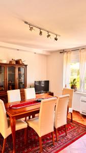 a dining room with a wooden table and chairs at Apartments Ivanović in Kotor