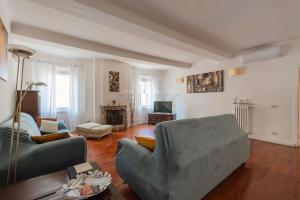 a living room with a couch and a chair at La Corte del Duca in Modena