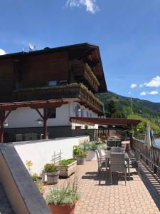 a patio with tables and chairs and a building at Schlossnerhof in Virgen