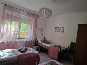a bedroom with two beds and a window at Vidam in Csengőd