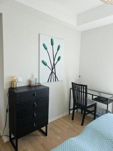 a bedroom with a dresser and a chair at Dugneberg in Karmøy