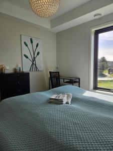 a bedroom with a bed with two towels on it at Dugneberg in Karmøy
