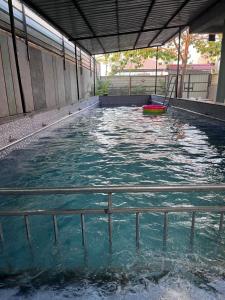 a pool of water with a red frisbee in it at Green Heaven Stay in Surat +6 photos