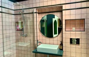a bathroom with a sink and a mirror and a shower at Norwood in Rushbrooke