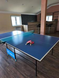 a ping pong table with a ping paddle on it at Dilijan Rest - Comfortable rooms & Pool in Dilijan