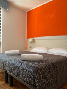 two towels are sitting on top of a bed at Hotel Mezzolago in Calceranica al Lago +18 photos