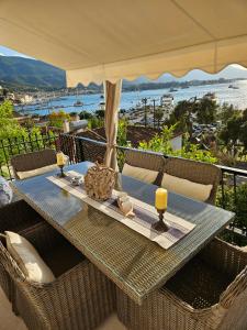 a table on a balcony with a view of the ocean at Archontikon 1800 in Poros